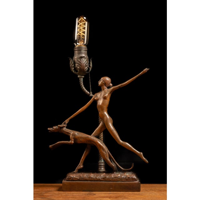 c. 1930s; S. C. Tarrant Co. Inc. - New York Vintage bronze statuary lamp. This piece features a large figural statuette...