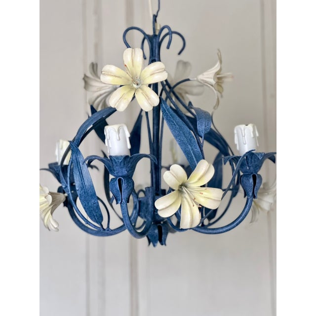 French four-light tole chandelier dating to the late 1960s-1970s. This decorative floral design features a sculptural open...