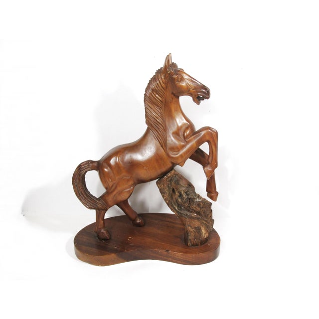 Beautifully carved stallion caught mid-rear, with clean mid-century lines and a textured natural wood “rock” for movement....