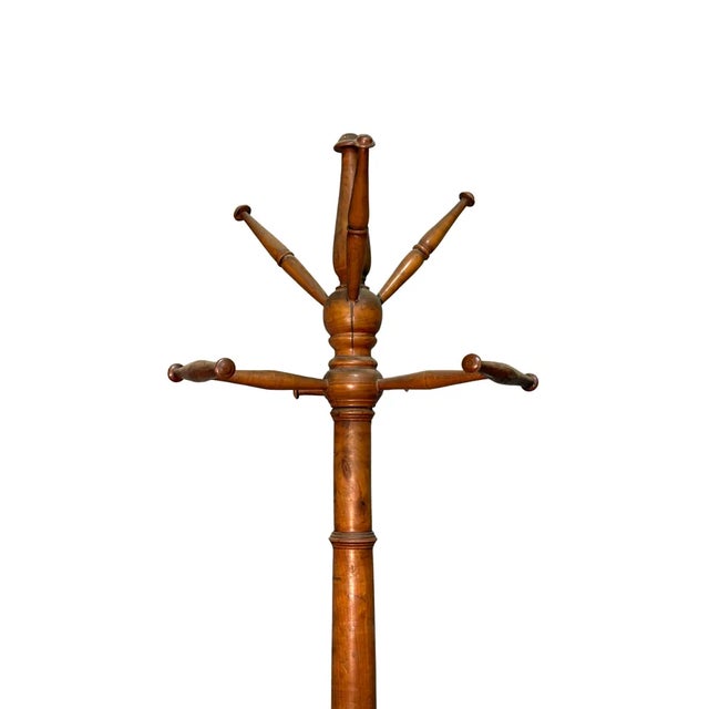 Vintage coat rack made of fine cherry wood, dating back to the late 19th century. The simple yet elegant structure retains...