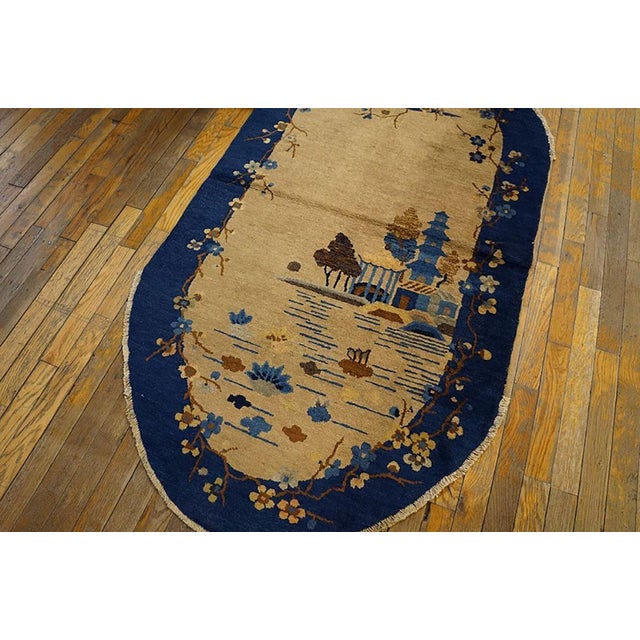 1920s Chinese Art Deco Oval Carpet ( 3' X 5'8" - 92 x 172 cm ) with an ivory background and navy border. Wool 1920s Ivory...