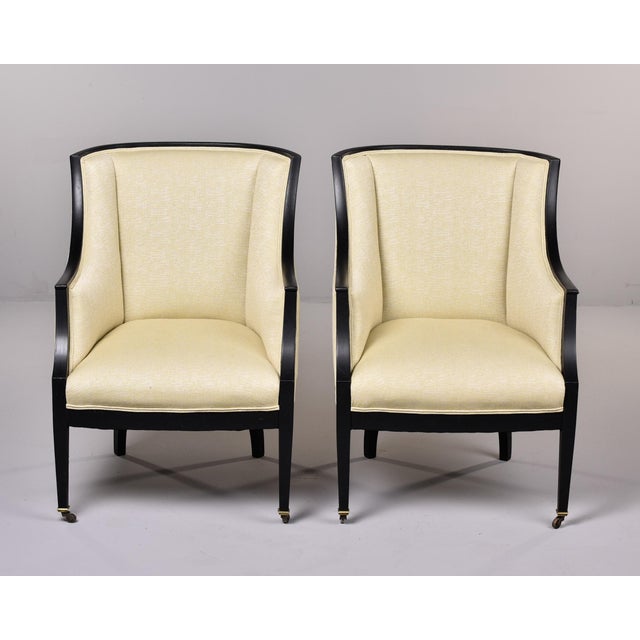 Found in France, this pair of Swedish armchairs date from the 1930s. Streamlined hardwood frames with a black painted...