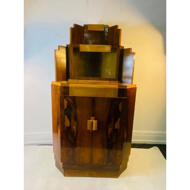 Exceptional Art Deco Marquetry Skyscraper Design Corner Cabinet Designed with Exotic Wood In Blonde And Burled Wood. A...