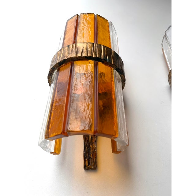 Pair of Mid-Century Modern wall lamps light sconces in amber and clear glass and hammered wrought iron, gilding gold...