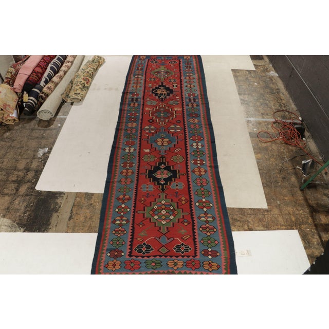 Handwoven in wool, a gracious 5x17 antique Bidjar kilim rug from our celebrated classic flatweave curations. Originating...