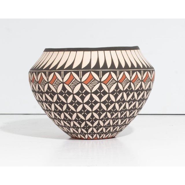An Acoma Pueblo pottery vessel by the Native American ceramicist Dorothy Trujillo (1932-1999). This rounded, bowl-shaped...