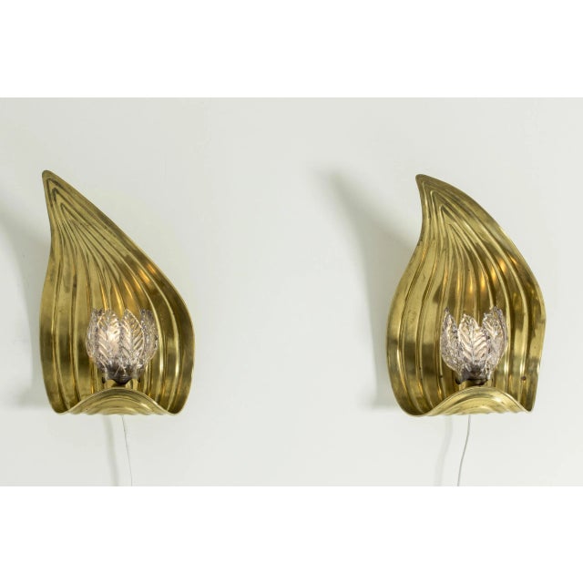 Pair of amazing brass wall lamps, made in Sweden in the 1940s. Made in the form of large leaves, with a glass shade...