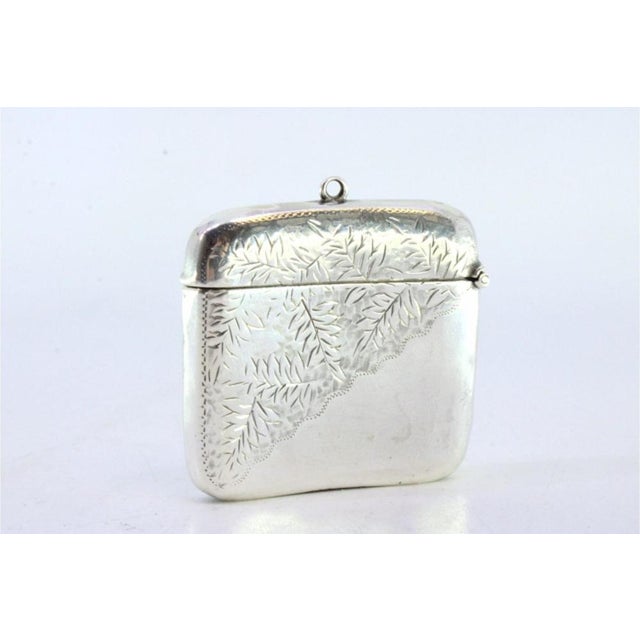 Silver Matchbox with Engraved Plant Motifs and Hanging Ring, in Very Good conditions. Designed 1890 to 1919 This piece has...