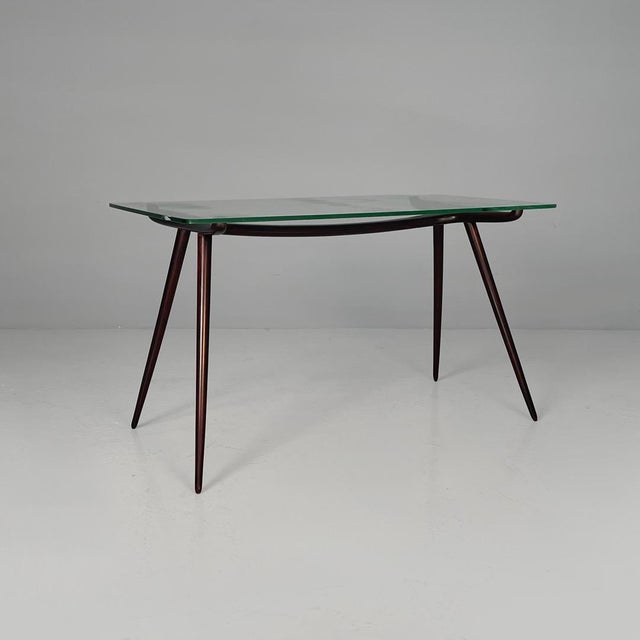Italian mid-century modern disassemblable coffee table in wood and glass, 1950s Coffee table with a rectangular glass top...