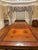 A large, rectangular mahogany dining table with decorative gold-tone or ormolu mounts along the apron and double pedestal...