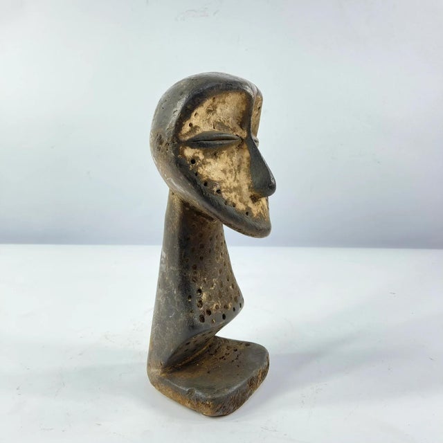 A hand-carved Lega figure originates from the Lega people in the Democratic Republic of the Congo. The figure is easily...