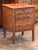 Late 19th century French walnut commode with three drawers and simple tapered legs. Retains its original ring pulls and...