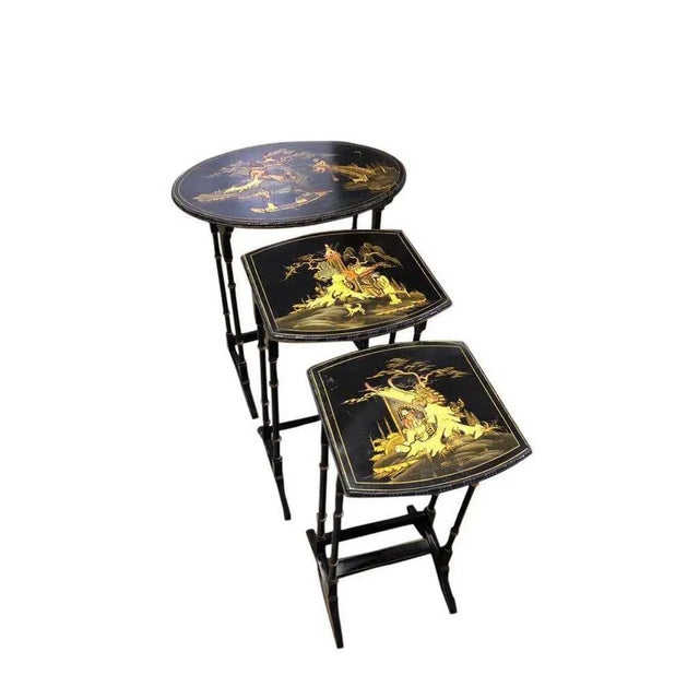 A superb set of three carved chinese chinoiserie nested tables, 19th century. The set each have a different scene, from a...