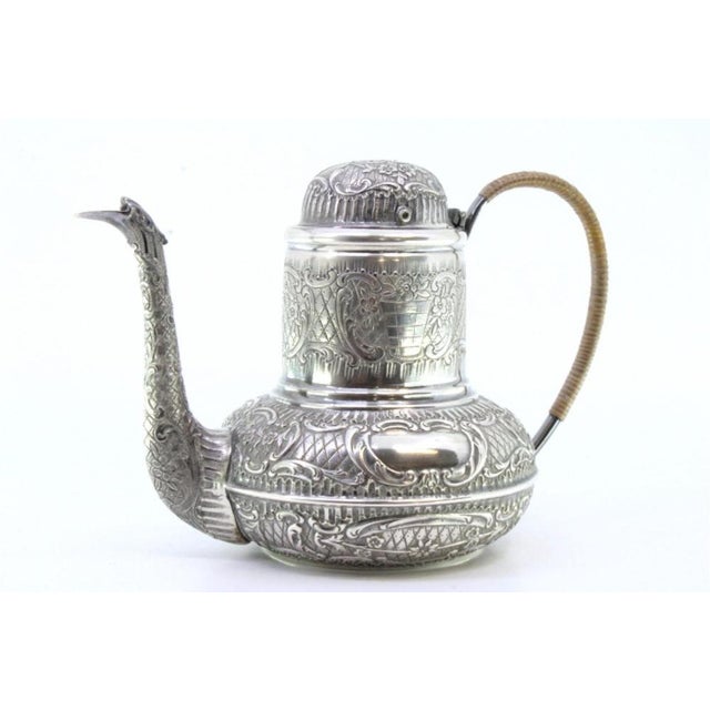 Round Silver Kettle with Reliefs, Monogram Card and Coated Handle, in Very Good conditions. Designed 1890 to 1919 This...