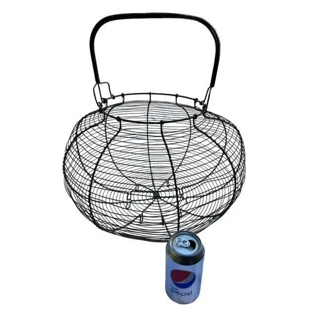 A large 1920s French wire egg basket — rustic farmhouse character. Measures 18"W x 18"D x 18"H. Lovely for gathering eggs,...