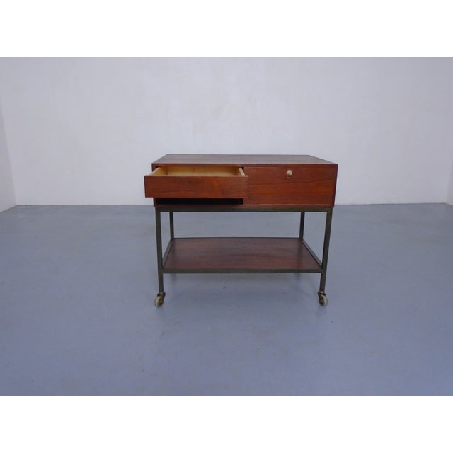 Small, rolling chest of drawers with one drawer and compartment with integrated pen tray in teak by Herbert Hirche for...