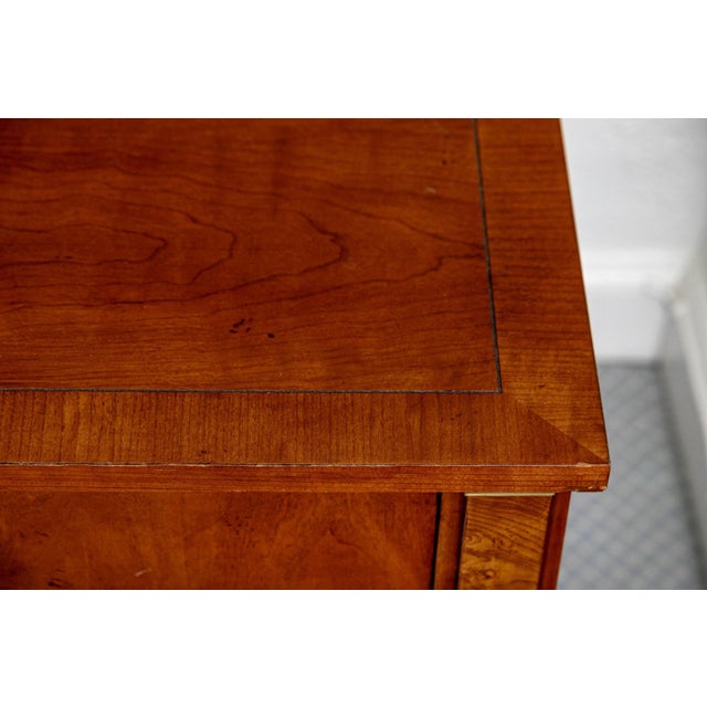 An exceptionally handsome, bench-made pair of end tables by the prestigious Baker Furniture Company, showcasing elegant...