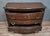A Louis XV style bombé commode in solid walnut, mid-20th century. The serpentine front opens with three large molded...