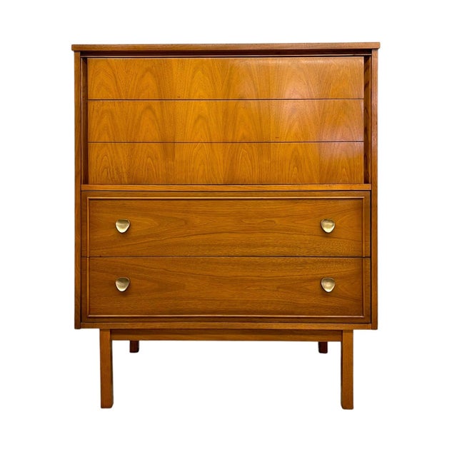 Vintage mid century modern highboy dresser by Dixie featuring a clean-lined silhouette with tapered legs, recessed framing...