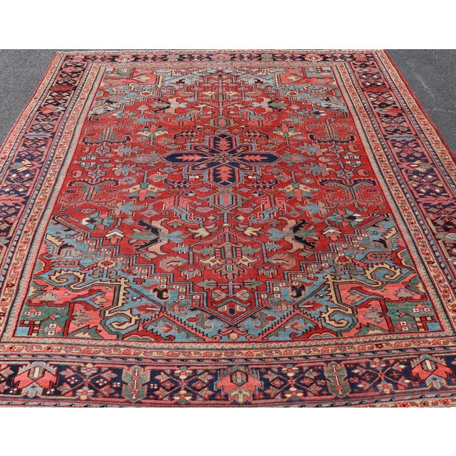 Brilliant Antique Heriz Rug with Central Medallion and Geometric Design. Made in the early 20th century in Iran, this...