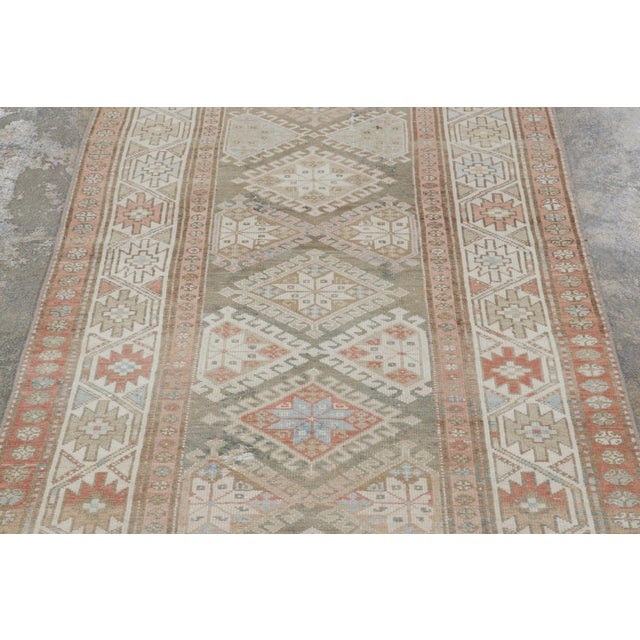 Hand-knotted in wool circa 1950-1960, this 3x15 vintage Persian Malayer extra-long runner rug is a masterclass in tribal...