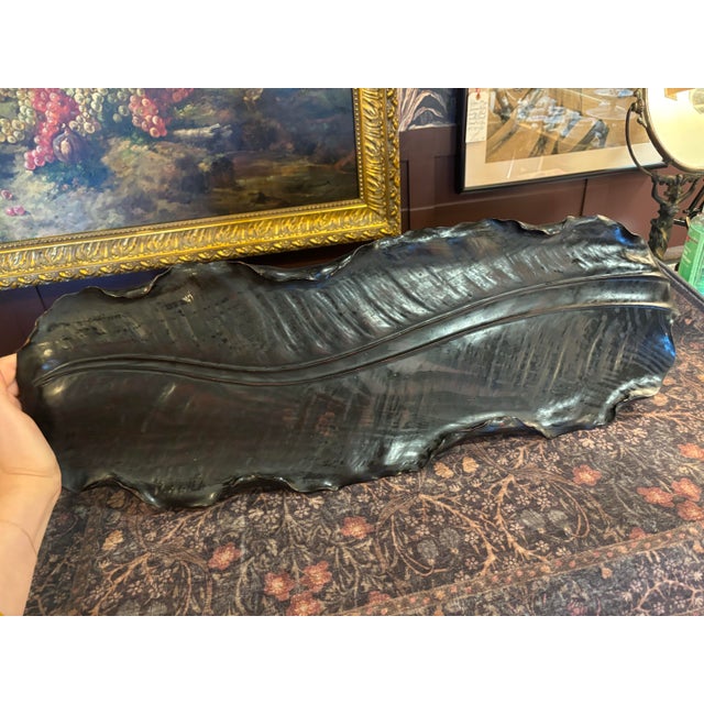 A striking and unusually large 19th-century Japanese carved wood tray, beautifully modeled in the naturalistic form of a...