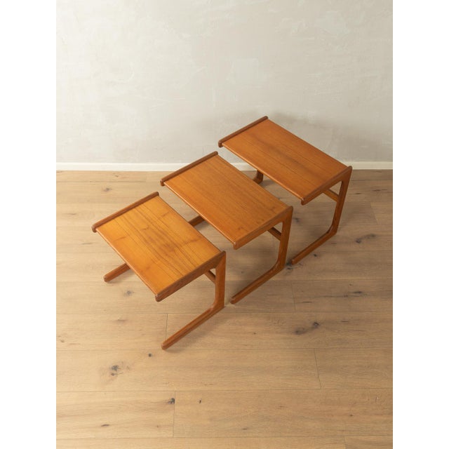 Classic nesting tables from the 1960s. Solid wood frame and veneered tabletop with a solid teak edge. Quality features:...