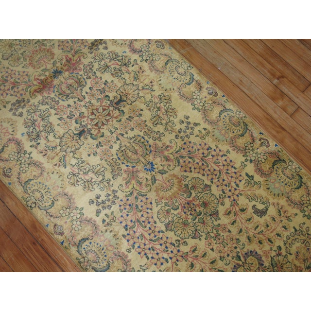A rare early 20th century feminine Persian Kerman traditional runner Measures: 2'8'' x 13'6''.