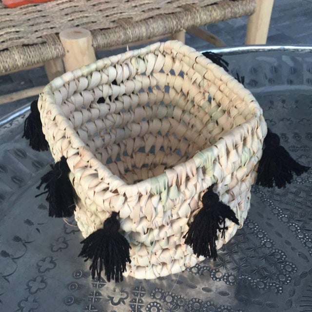 This cute little basket is hand-woven by local artisans and the tassels are handmade and applied by a women's cooperative...