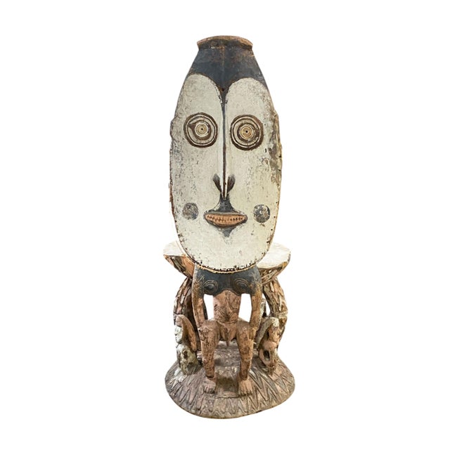 This Museum quality carved wooden stool features humanoid figures supporting the seat, with a prominent figure at the back...