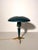 A distinctive Philips table lamp designed by Louis Kalff, featuring a broad dome shade, tapered stem and sculptural tripod...