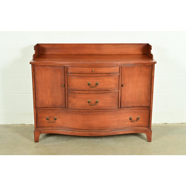 An exceptional Federal or Hepplewhite style serpentine front sideboard, buffet, bar cabinet, or credenza By Morganton...