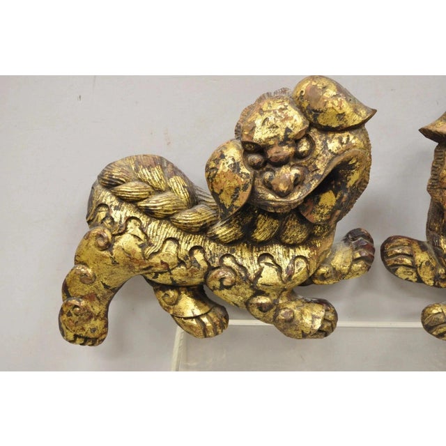 Vintage Carved Wood Gold Gilt Chinese Foo Dog Figurines - a Pair. Item features solid carved wood construction, gold...