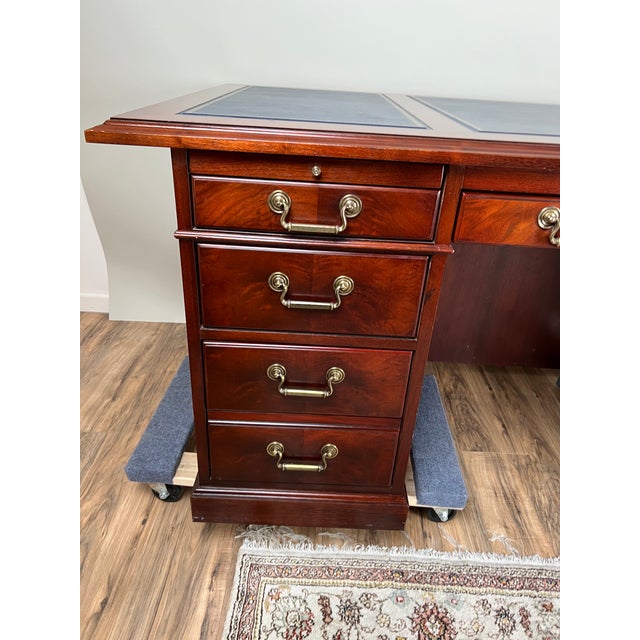 A stately vintage mahogany executive desk by Kimball, a maker long associated with fine American office furnishings. This...