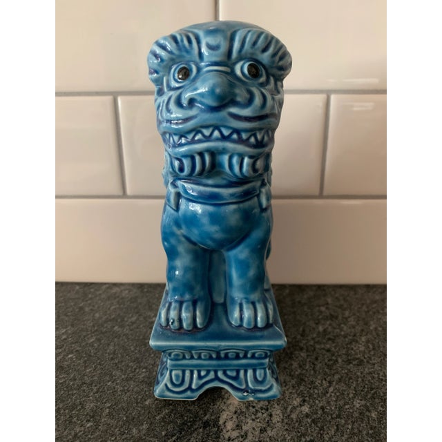 A striking vintage Chinese guardian lion, commonly known as a foo dog, crafted in glazed ceramic with a rich variegated...