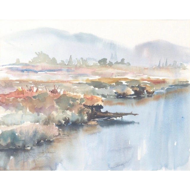 Soft landscape of the edge of a lake with mountains in the background by a California watercolor artist.. Signed in pencil...