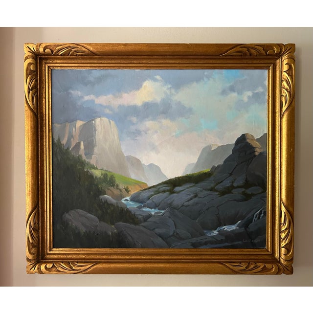 Vintage oil painting of a Rocky Mountain landscape in ornate gold frame. Signed to the lower right corner Lockwood....