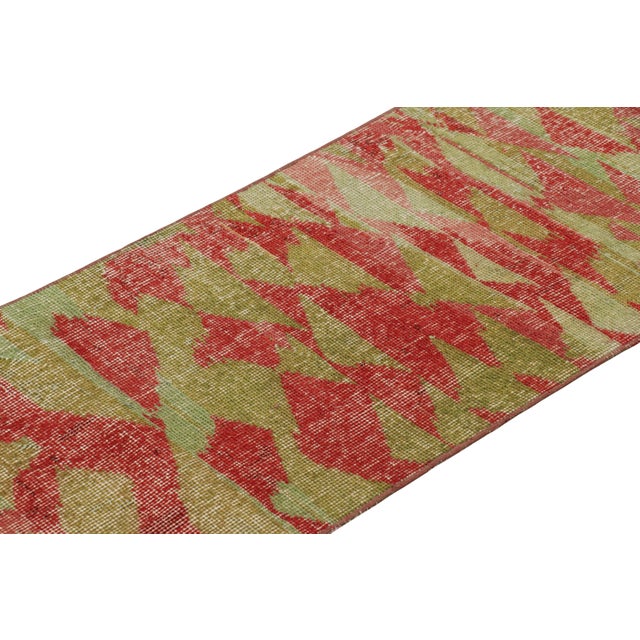 Hand-knotted in wool and originating from Turkey circa 1960 – 1970, this 2x7 vintage Zeki Müren runner rug is a unique...