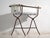 This antique bathtub in enamelled iron rests on a folding stand of bent iron tube. Originates from Central Europe, from...