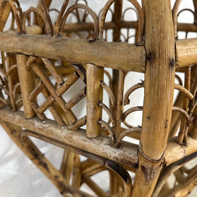 This is a handcrafted rattan sculptural form plant stand The piece has a tall, urn-like silhouette: wide through the...