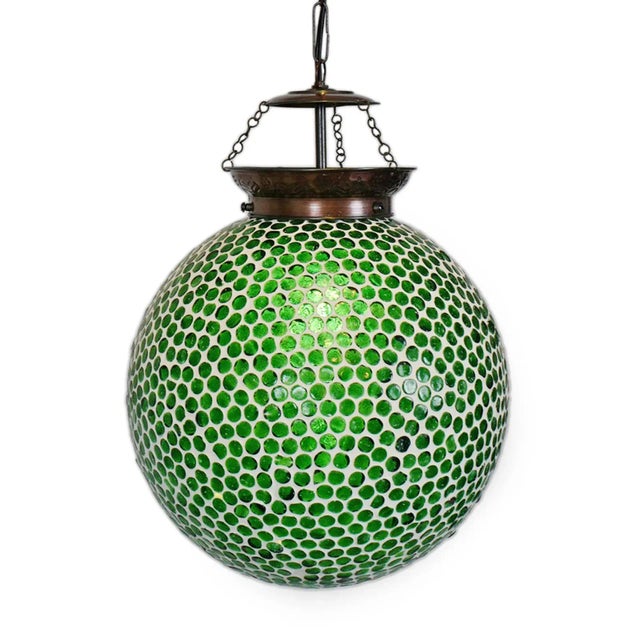 Green mosaic globe pendant lamp. Hand crafted in India with intricate small colored glass mosaic work. Each varies...