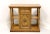 A Mediterranean style console cabinet with open shelves by Bernhardt. Walnut with a distressed finish, burl to door front,...