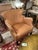 Leather club chairs having a beautiful compact and comfortable silhouette, finished with brass nailheads. Some minor...