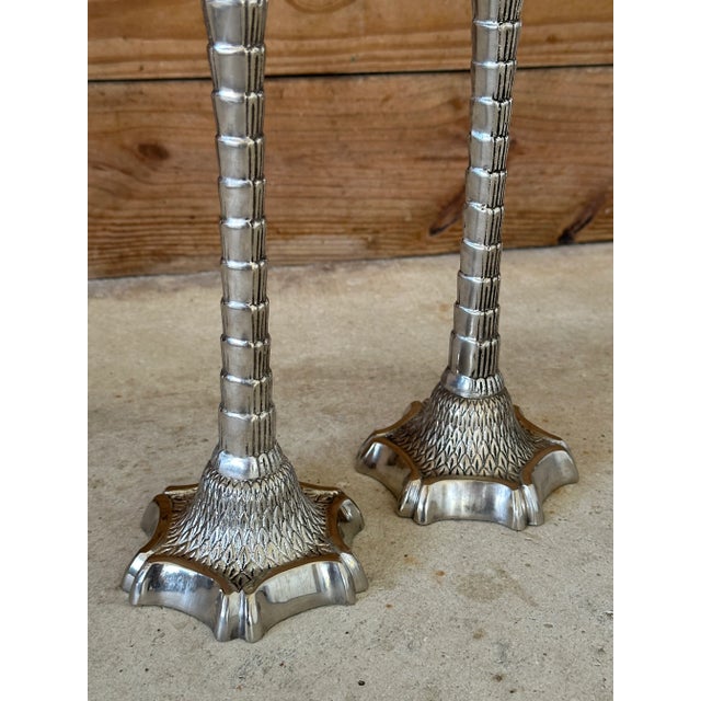 Fabulous pair of decorative palm tree candlesticks by the John Richard Collection, made in India. Featuring an intricate...