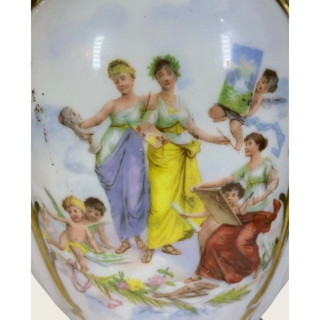 10.5” high, a very scarce Royal Vienna chocolate pot featuring a scene of GrecoRoman women as artists and sculptor with...