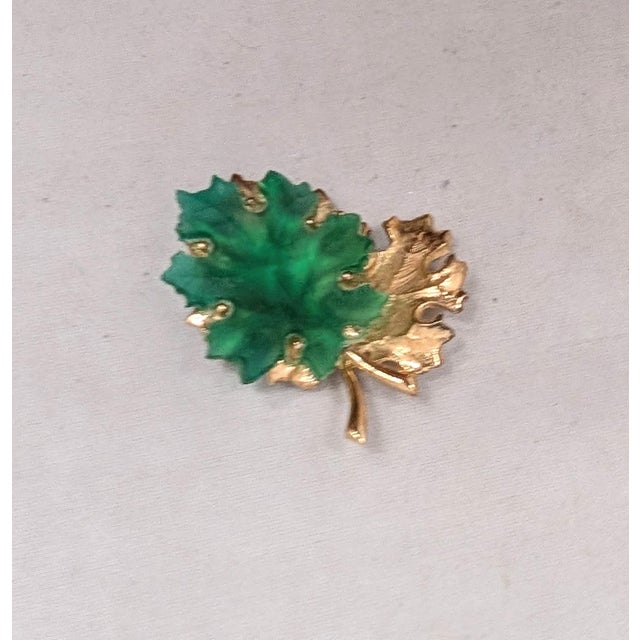 1960s goldtone over sterling textured leaf with green glass leaf overlapping it brooch with security clasp. Marked "NAPIER...