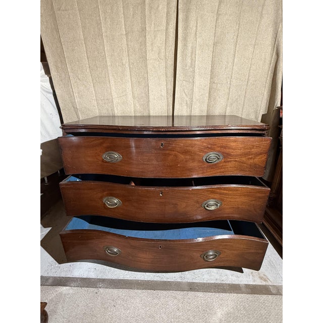 A fine late 18th to early 19th century George III bow front chest of drawers, crafted from richly patinated mahogany with...