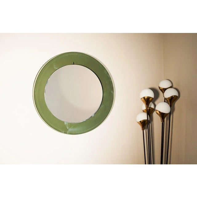 Wall mirror, prod. Cristal Art, Italy circa 1960, green concave shaped glass, mirror glass, wood suspension. Very good...