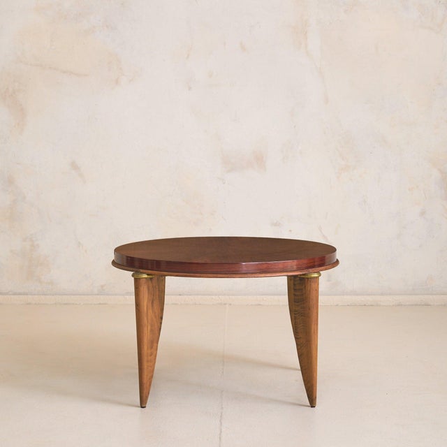 A French Art Deco coffee table by Maurice Jallot, dating to the 1940s. Crafted from sycamore maple, the round top is laid...