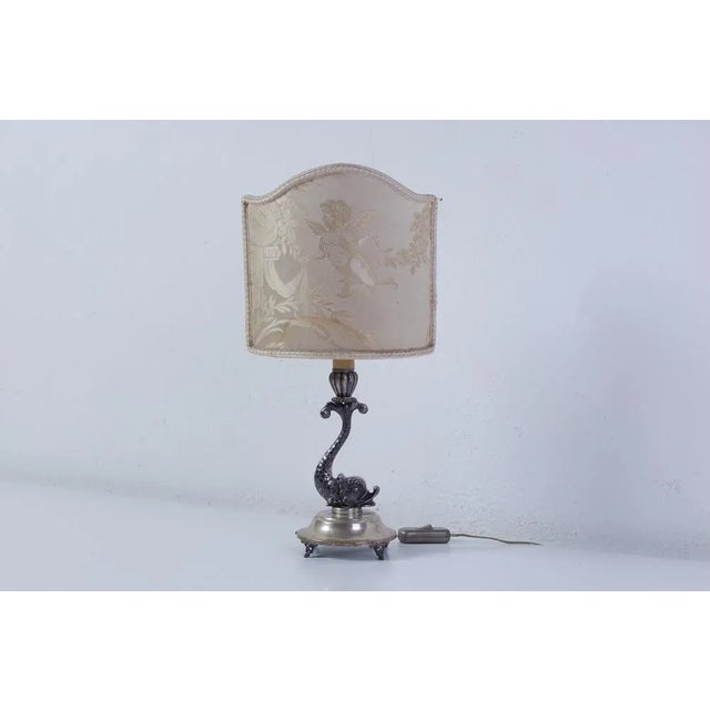 Interesting late 19th century table lamp. Base in 800 silver as per the hallmark on the same. Unique dolphin shape....